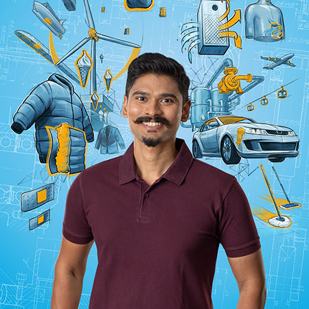 Blue background with different graphics and a man wearing a red shirt and smiling into the camera is displayed in the center of the photo