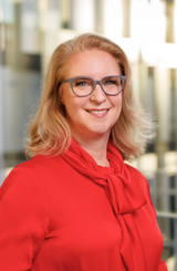Photo shows Esther Maria Loidl, CHRO of the Freudenberg Group, wearing a red blouse.