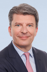 Picture shows Mr. Mathias Thielen, Chairman of the Board of Partners of Freudenberg & Co. Kommanditgesellschaft, wearing a grey suit and a light red tie.