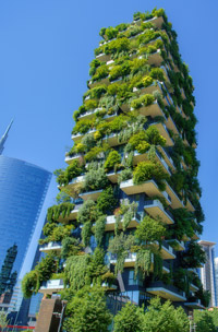 a tall buidling with a green facade full of plants