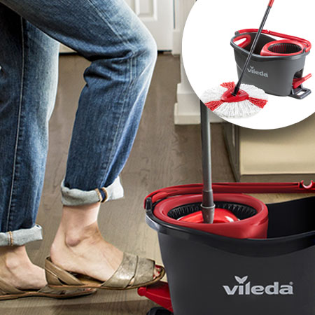 Close up of a grey cleaning bucket and female feet in sandals next to it with a picture of a cleaning bucket and its mop in the right corner