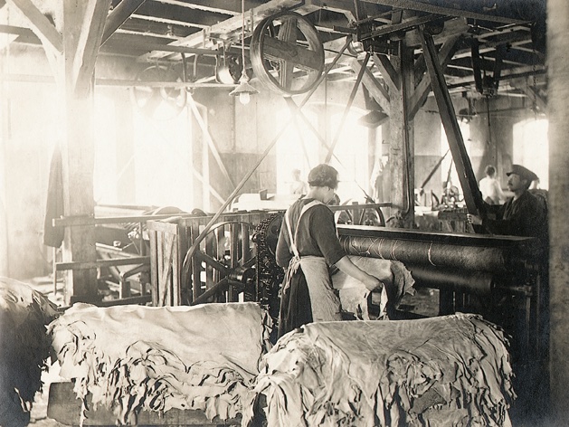 Picture is showing a tannery factory from the inside where people are working
