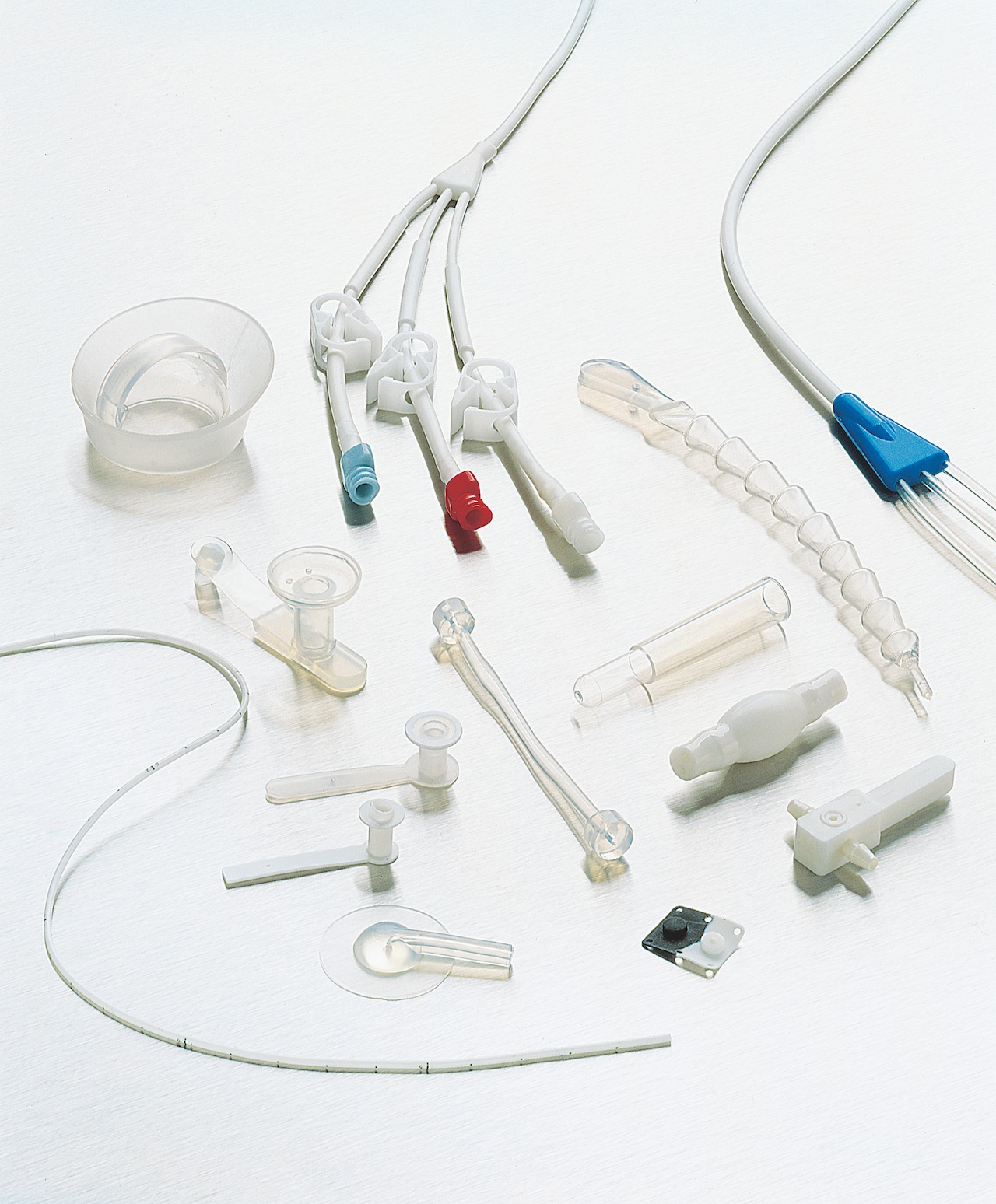 Picture shows different medical products, such as cathethers, laying on a white surface
