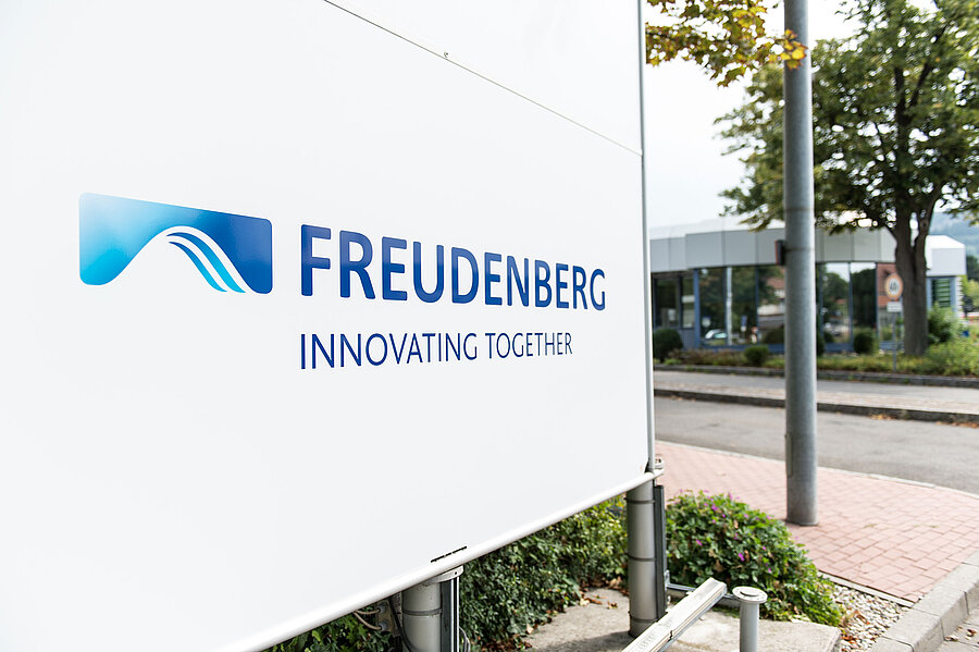 Weißes Schild, auf dem das Freudenberg Logo zu sehen ist