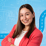 Portrait of a female person shown in the center of the picture against a blue background.