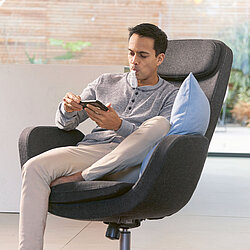 a man sitting in a chair using the signifier