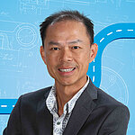 Portrait of a male person shown in the center of the picture against a blue background.