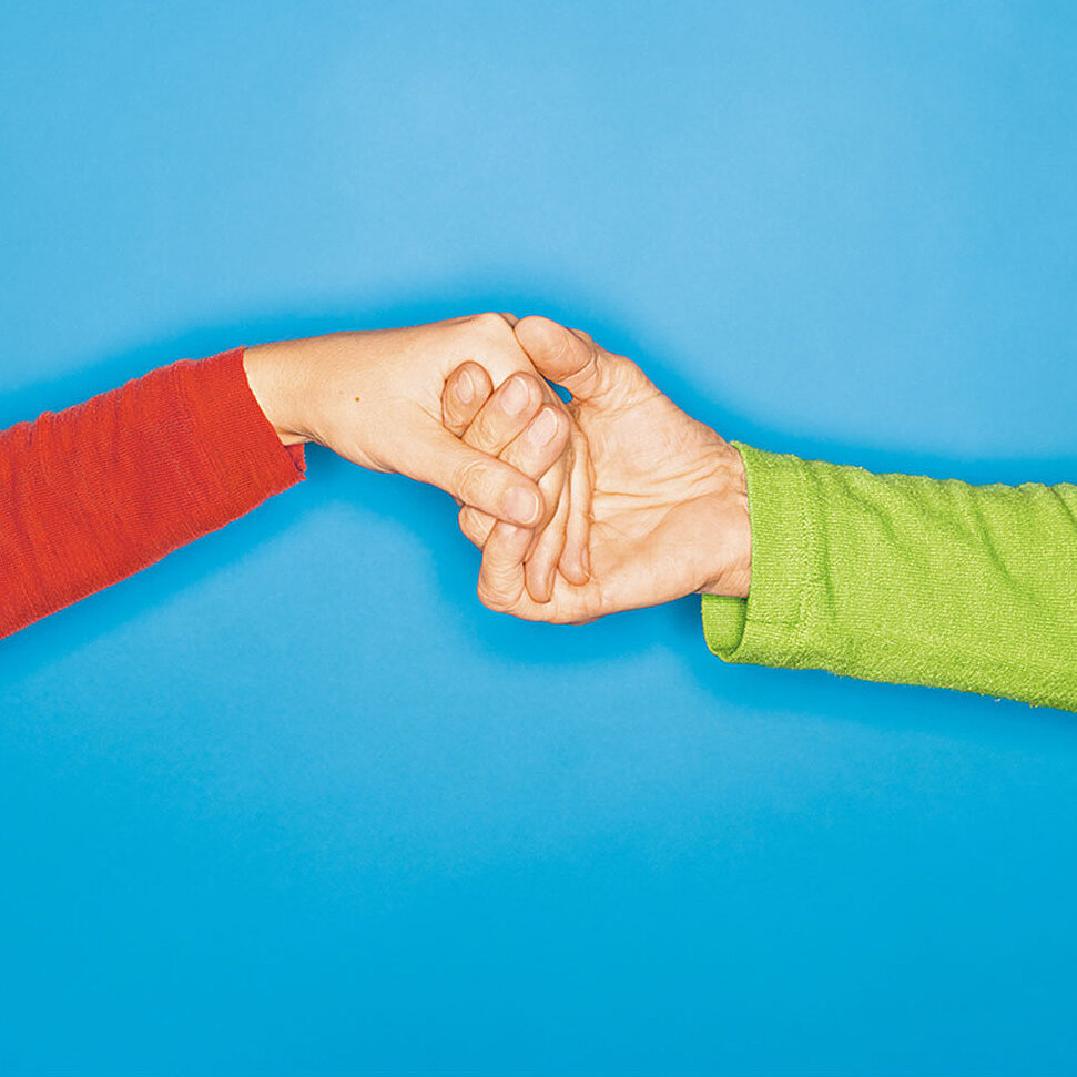 Photo of two hands holding each other