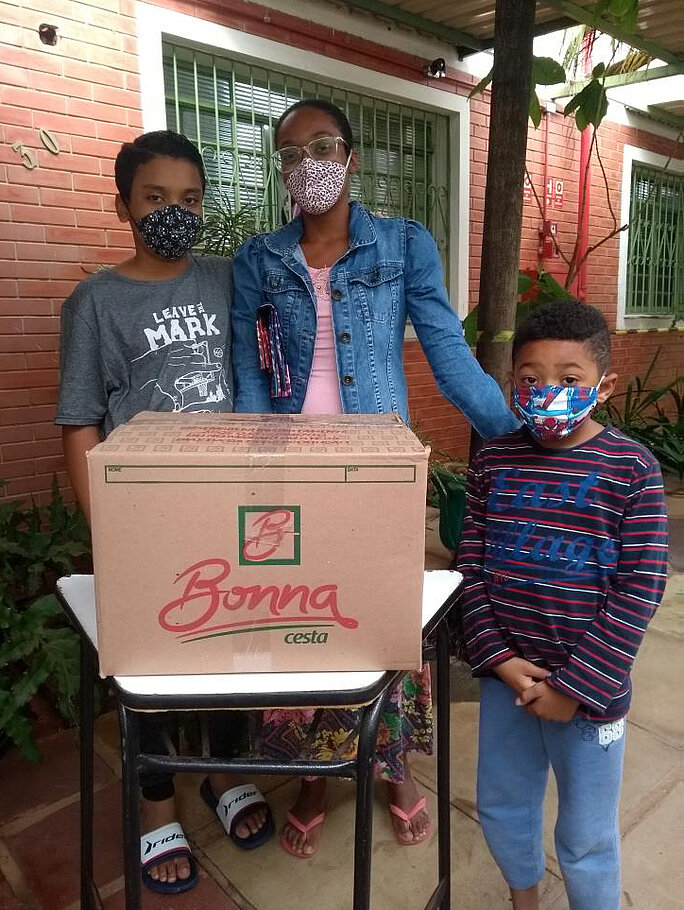 Mother with her two children receives a food package.