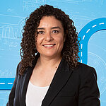 Portrait of a female person shown in the center of the picture against a blue background.