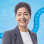 Portrait of a female person shown in the center of the picture against a blue background.