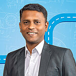 Portrait of a male person shown in the center of the picture against a blue background.