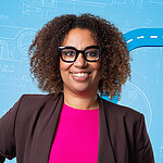 Portrait of a female person shown in the center of the picture against a blue background.