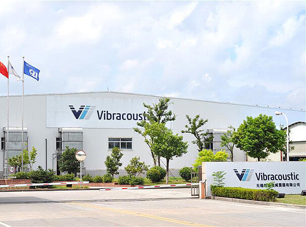 Photo shows a white building that has a banner on which Vibracoustic is written