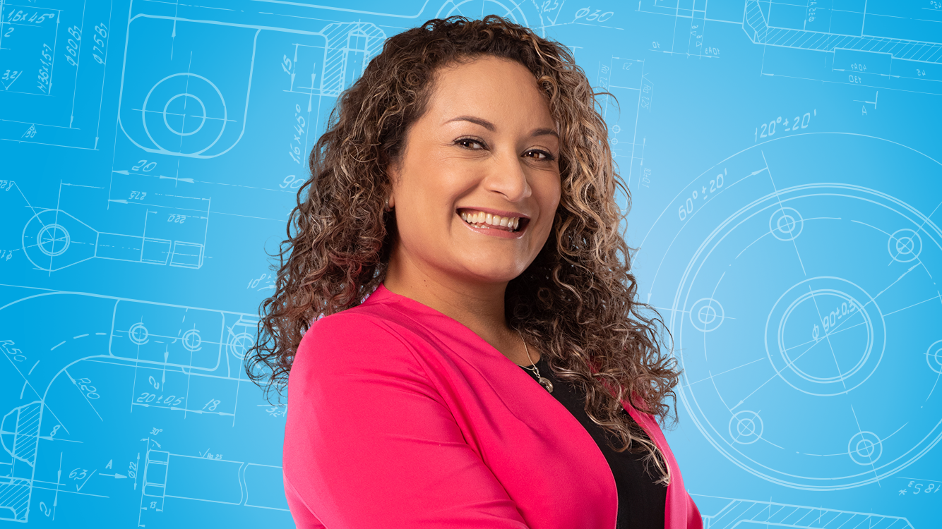 Portrait of a female person shown in the center of the picture against a blue background.