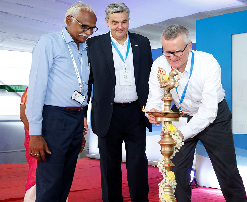 Three persons during ceremonial lamp lightning