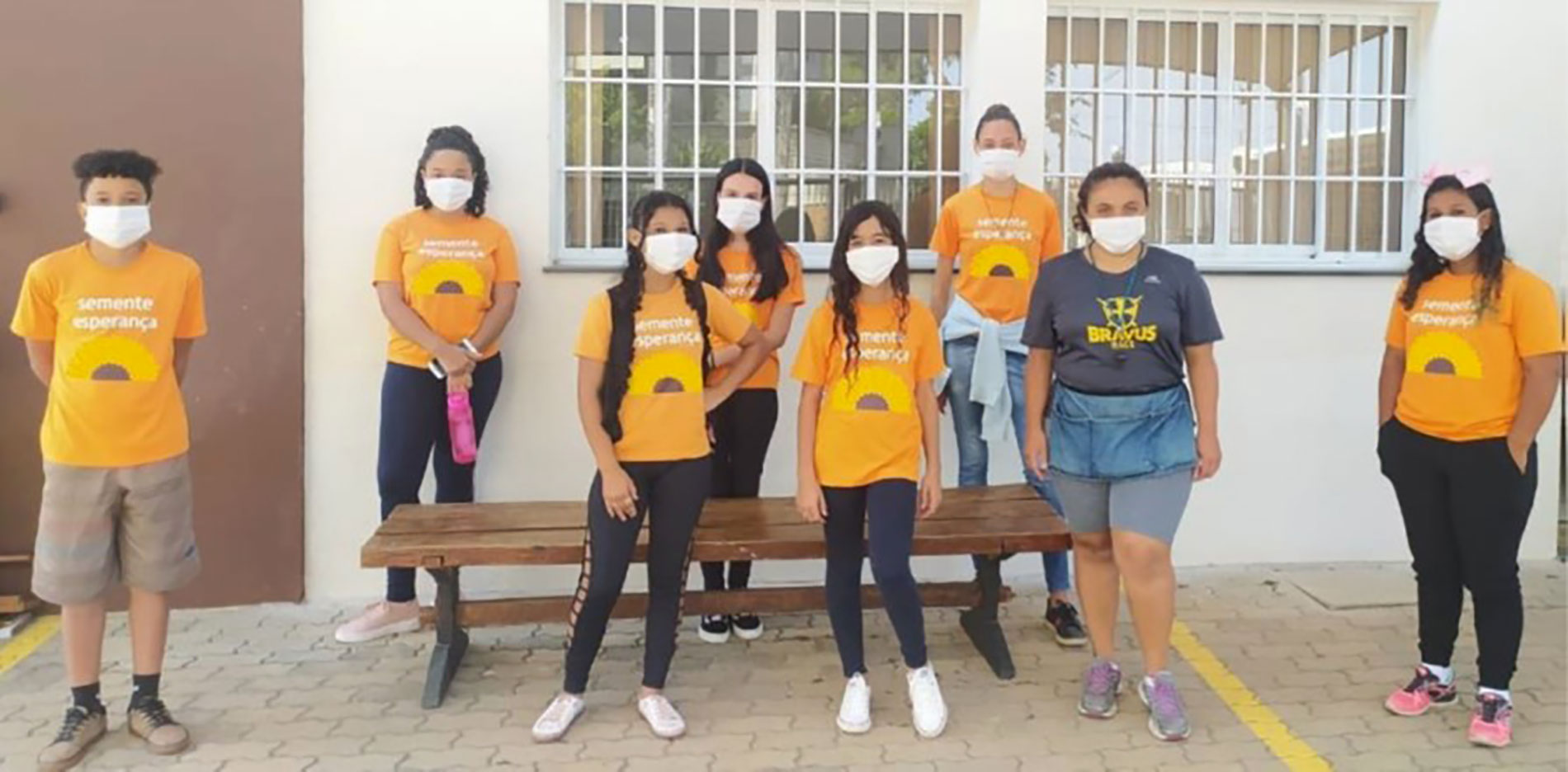 Group of children ans carers in front of a building