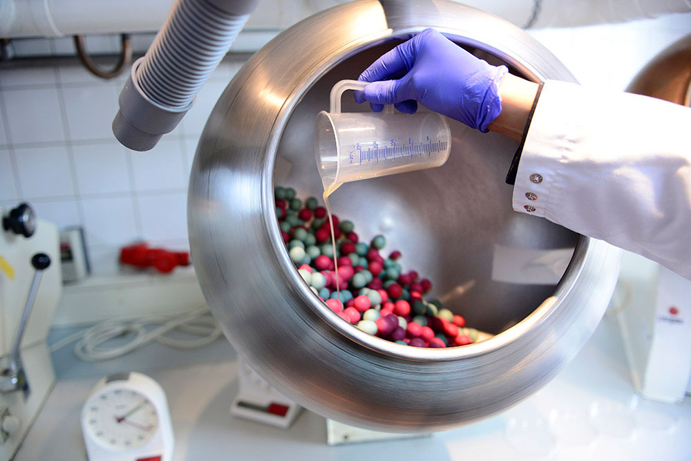 sugar-coated tablets rotate in a drum